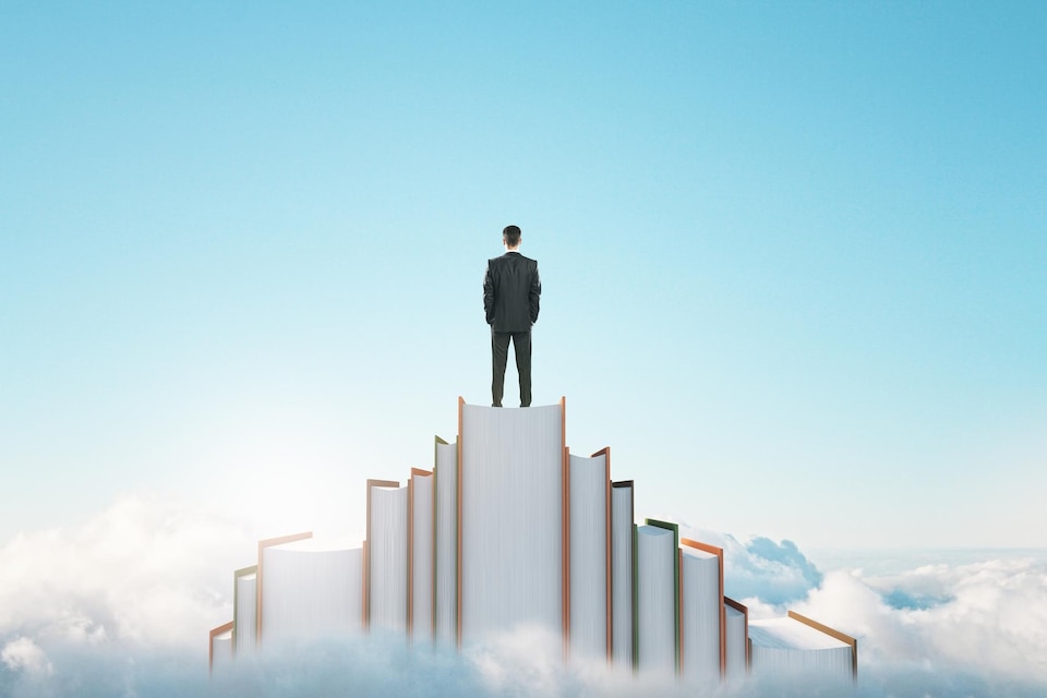 [freepicdownloader.com]-success-through-knowledge-reading-concept-with-proud-businessman-back-view-top-books-rock-clouds-looking-into-blue-sky-large